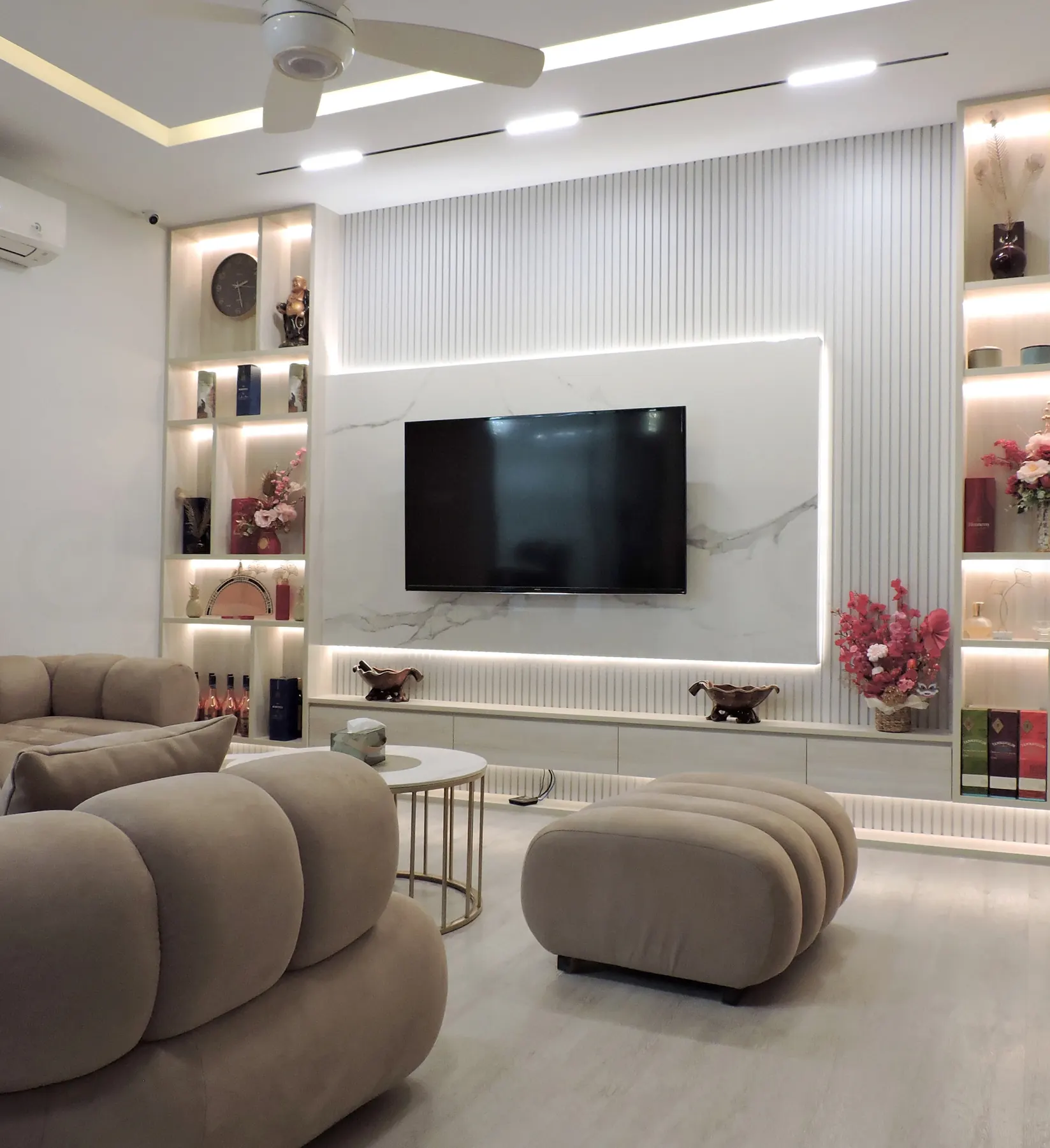 Lounge seating in front of a marble television wall