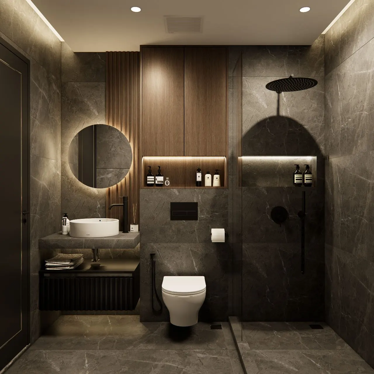 Bathroom in dark stone with a round backlit mirror